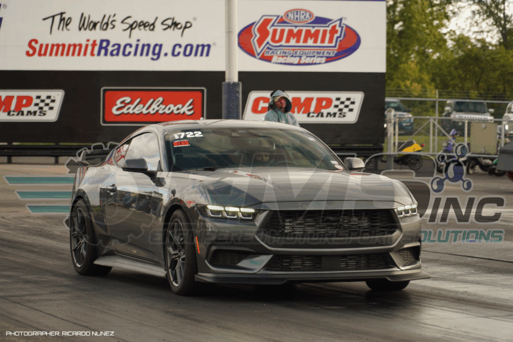 This image captures the Engineered Motorsport Solutions (EMS) S650 EcoBoost Mustang at the drag strip during testing. The car is seen staged on the starting line with track signage from Summit Racing and Edelbrock in the background, emphasizing a professional motorsport environment. The photo showcases the new generation S650 Mustang equipped with EMS performance tuning, highlighting its aggressive stance and readiness for high-performance runs. The image’s purpose is to visually represent EMS’s real-world testing and racing development for their new S650 EcoBoost tuning program, reinforcing credibility, engineering excellence, and results-driven performance.