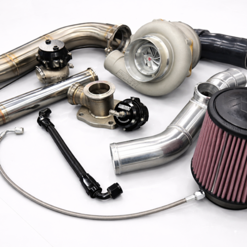 EMS EcoBoost big turbo kit with stainless piping, turbocharger, intake filter, and full installation components displayed on a white reflective surface