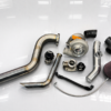 EMS EcoBoost big turbo kit with stainless piping, turbocharger, intake filter, and full installation components displayed on a white reflective surface