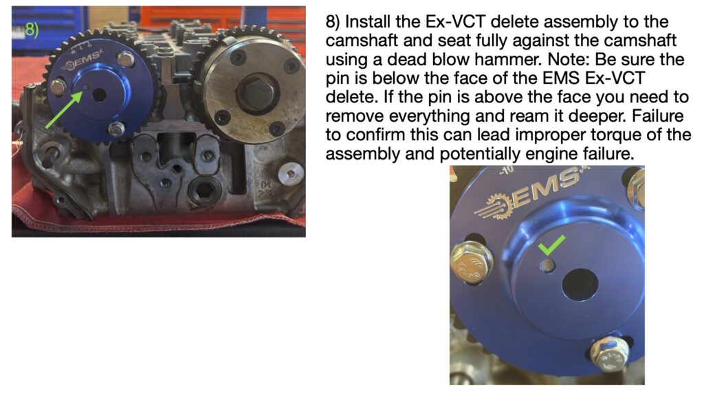 EMS VCT lockout assembly installed onto the exhaust camshaft and fully seated against the camshaft face. Green arrow identifies the completed assembly position.